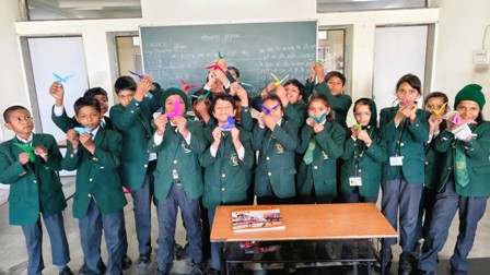 With tiny folds and colours bright, Paper birds took happy flight